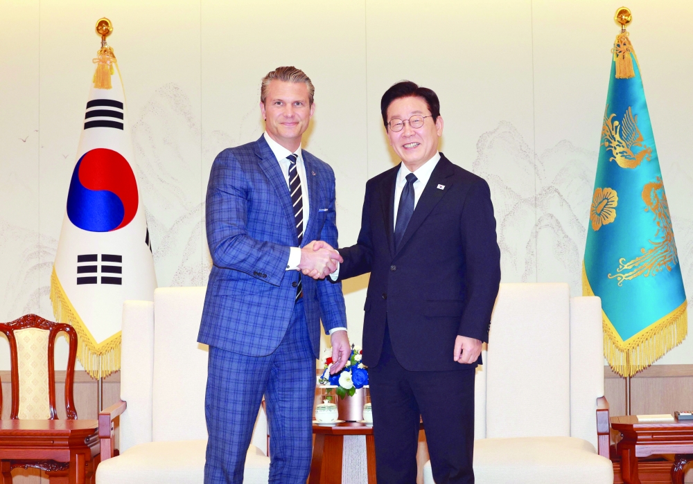 US Defense Secretary Pete Hegseth shakes hands with South Korean President Lee Jae Myung, at the Presidential Office in Seoul. — Reuters