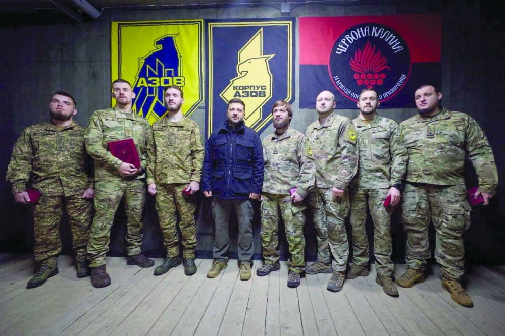 Ukraine's President Volodymyr Zelensky poses for a picture together with service members,  in the town of Dobropillia in Donetsk region. — Reuters