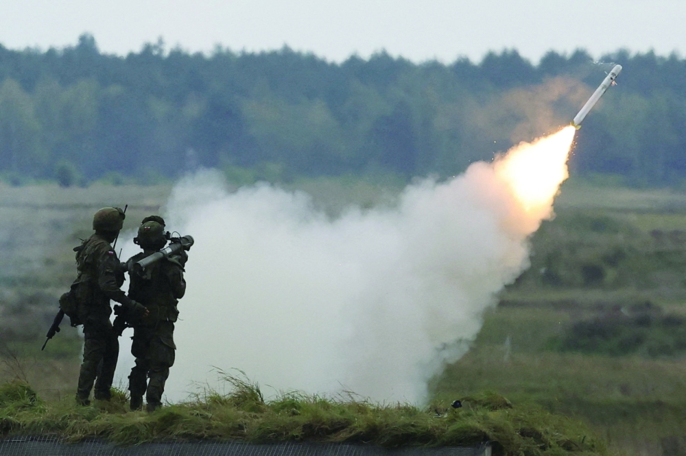 Polish soldiers fire from a man-portable air-defence system Piorun as they take part in Polish forces with Nato soldiers hold military exercises 'Iron Defender' at a military range in Wierzbiny near Orzysz, Poland. — Reuters File
