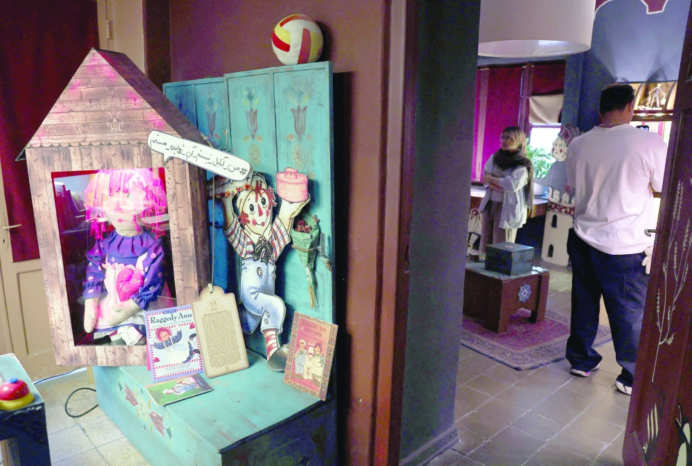 A visitor looks at items displayed at a toy museum.