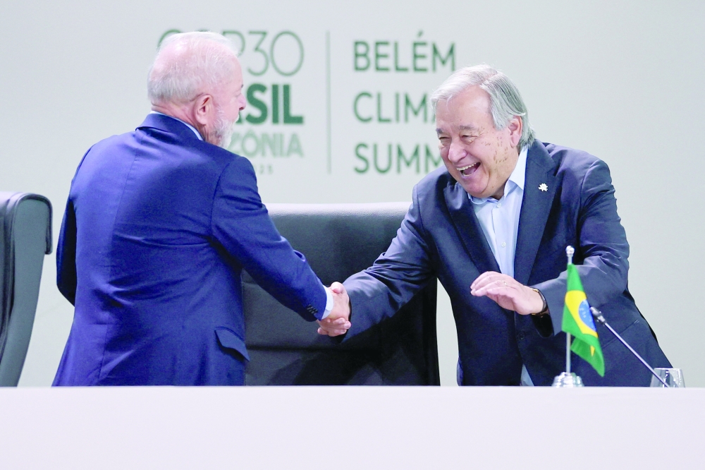 Brazil's President Luiz Inacio Lula da Silva and United Nations Secretary-General Antonio Guterres shake hands at the opening of the Belém Climate Summit plenary session, as part of the United Nations Climate Change Conference (COP30), in Belém on Thursday. — AFP