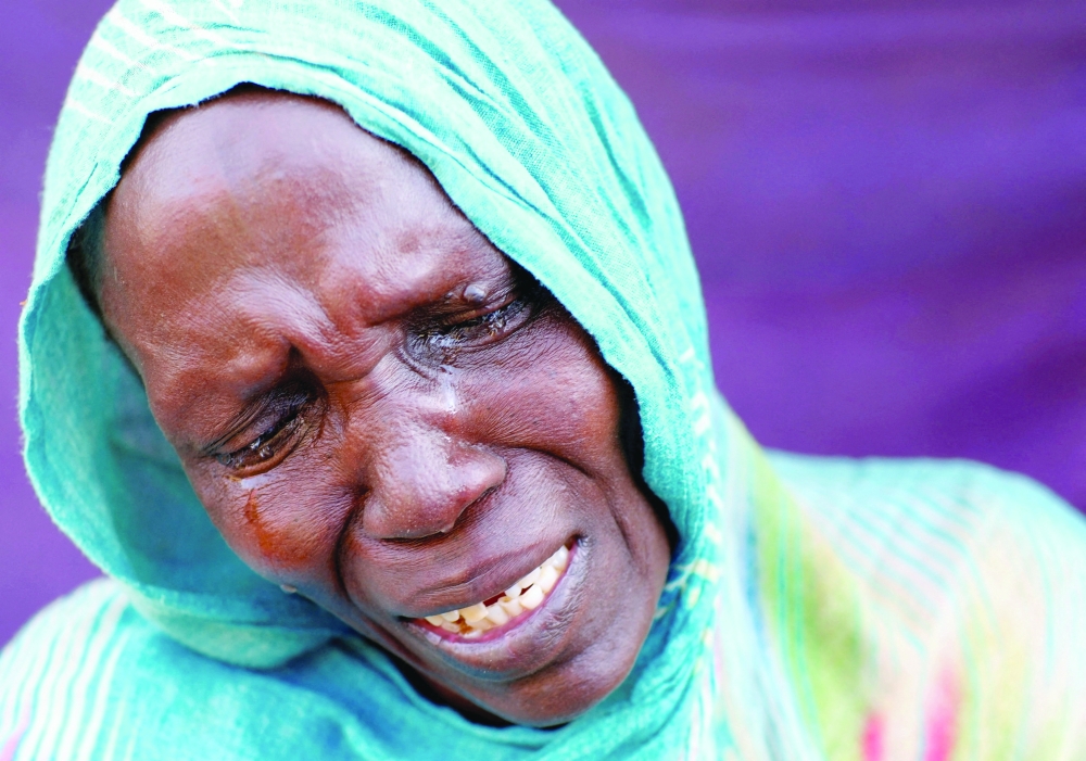 A woman from El Fasher cries after learning about the killing of her son and brother, in a camp in Al Dabbah, Sudan. — Reuters