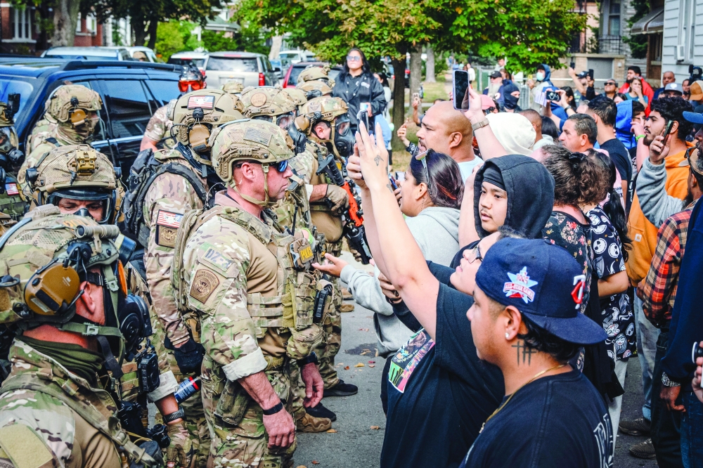 Protesters confront federal officers in the East Side neighbourhood of Chicago. — NYT file photo