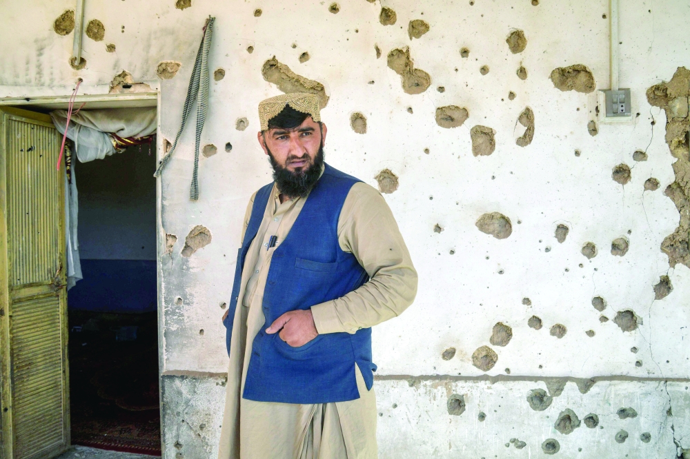 An Afghan man stands in front of a damaged house, at a village in the Spin Boldak district of Kandahar. — AFP