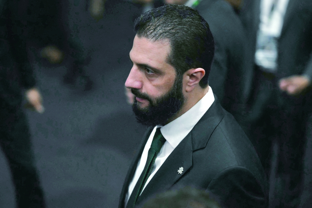 Syria's President Ahmad Al Sharaa walks on arrival at the General Plenary of Leaders in the framework of the COP30, in Belem, Para State, Brazil. — AFP