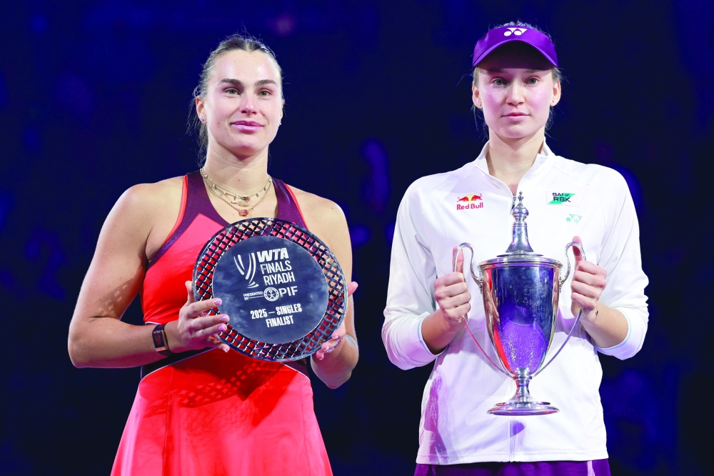 Kazakhstan's Elena Rybakina poses with the trophy after winning the final match, alongside runner-up Belarus' Aryna Sabalenka. — Reuters