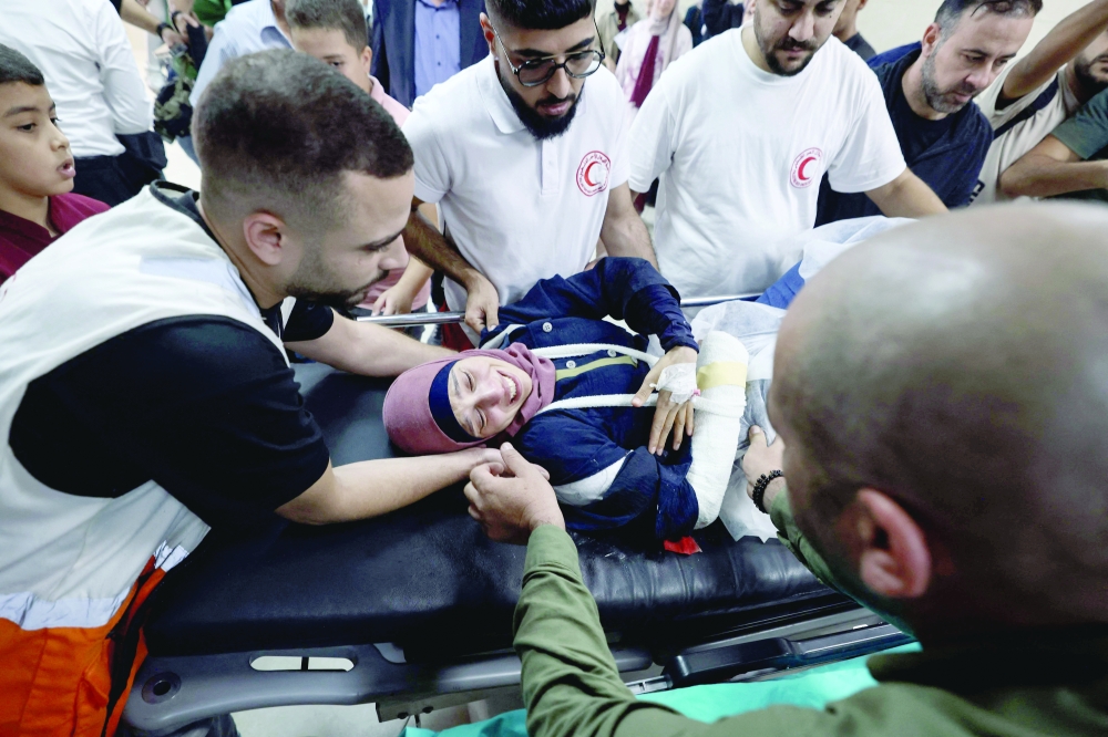 Palestinian photographer Raneen Sawafta reacts at Rafidia Hospital in Nablus in the West Bank. — AFP