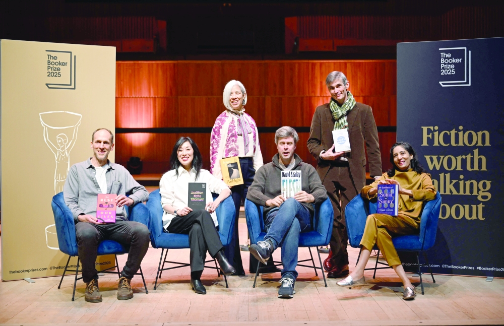 (L-R) British-US author Ben Markovits poses with his book 'The Rest of Our Lives', US author Katie Kitamura with her book 'Audition', US author Susan Choi with her book 'Flashlight', Hungarian-British author David Szalay with his book 'Flesh', British author Andrew Miller with his book 'The Land in Winter' and Indian author Kiran Desai with her book 'The Loneliness of Sonia and Sunny' during the Booker Prize 2025 shortlist photo call in London on the eve of the award announcement. — AFP