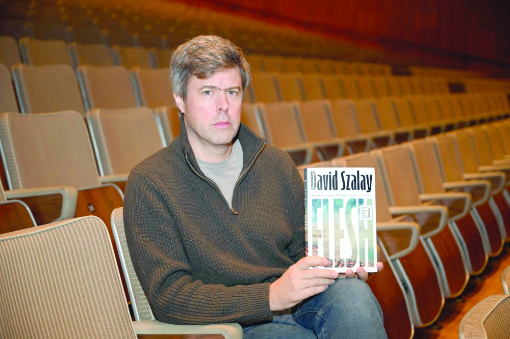 David Szalay poses with his book 'Flesh' in London. — AFP