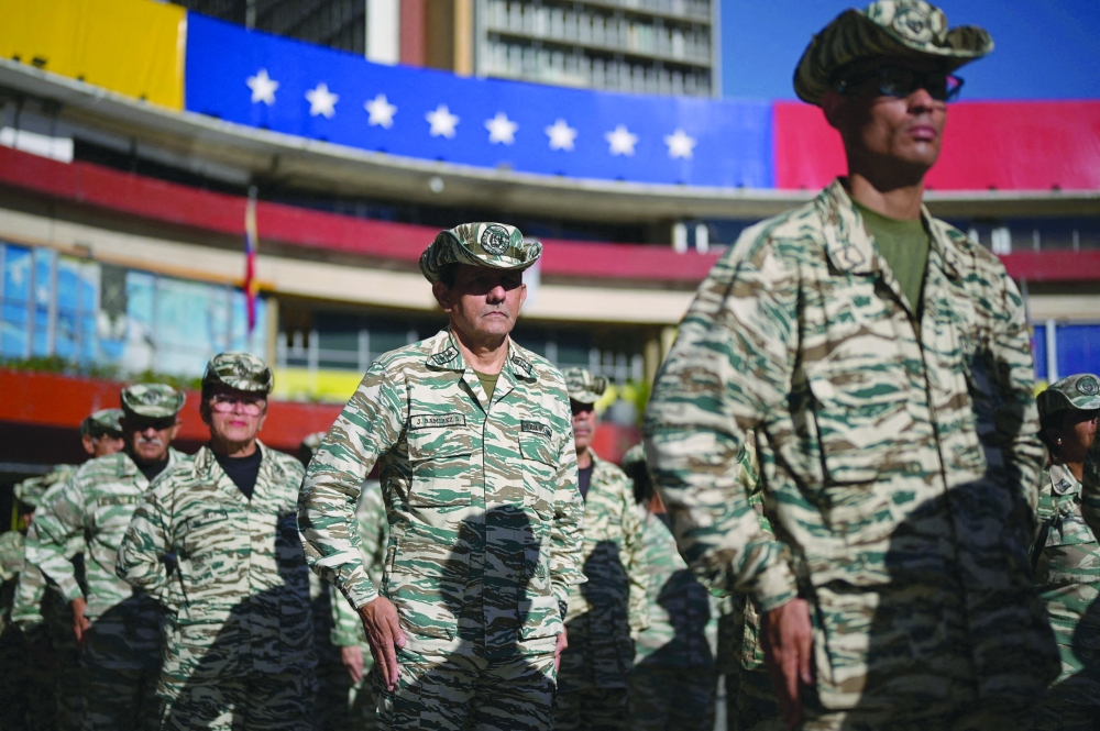 Members of the Bolivarian group stand in formation during a military training, in Caracas. — Reuters