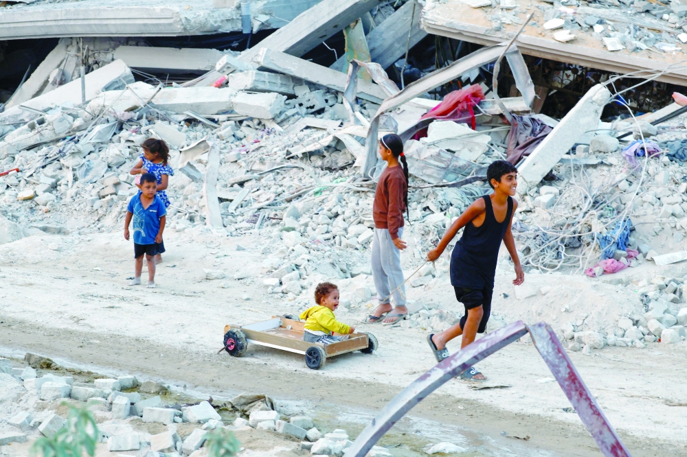 Palestinian children play among the rubble of destroyed buildings, amid a ceasefire between Israel and Hamas, in Jabalia.— Reuters