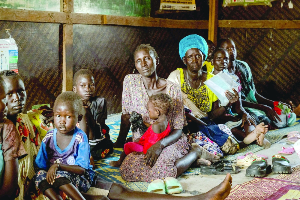 A group of women and their children wait for the Targeted Supplementary Feeding Programme (TSFP) activities, in Bentiu, South Sudan. — AFP