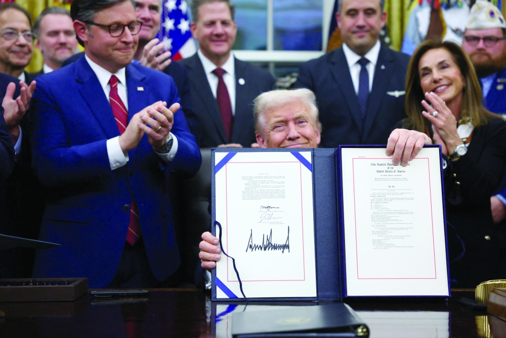 US President Donald Trump signs the funding bill to end the US government shutdown, at the White House in Washington, DC. — Reuters