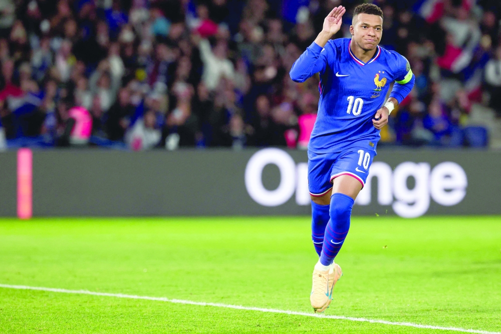 TOPSHOT - France's forward #10 Kylian Mbappe celebrates after shooting a penalty kick to score his team first goal during the 2026 World Cup qualifiers Europe zone group D football match between France and Ukraine at the Parc des Princes stadium in Paris, on November 13, 2025.   (Photo by FRANCK FIFE / AFP)

