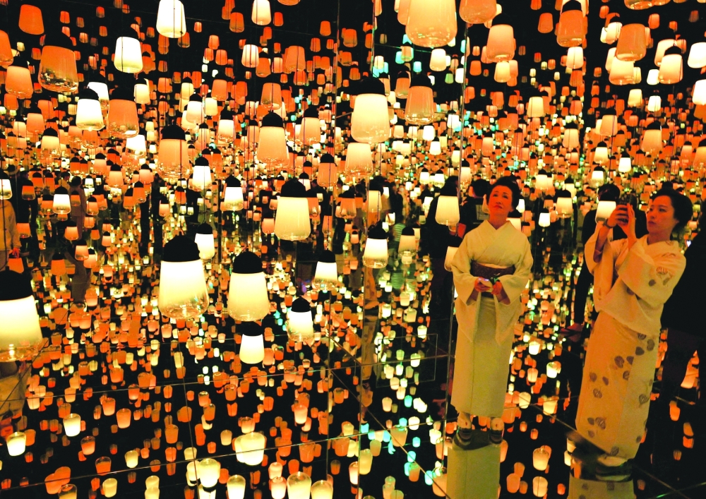 Visitors wearing traditional Japanese kimonos watch digital artwork at teamLab Biovortex in Kyoto. — Reuters