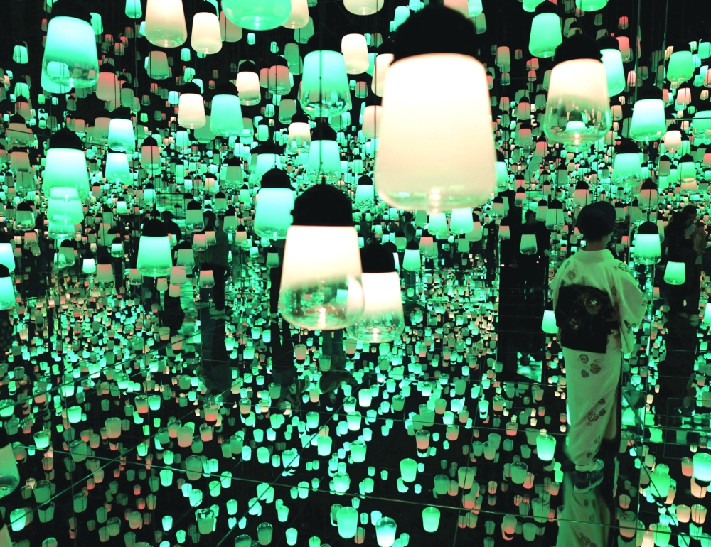 A visitor wearing a kimono watches digital artwork at teamLab Biovortex in Kyoto. — Reuters