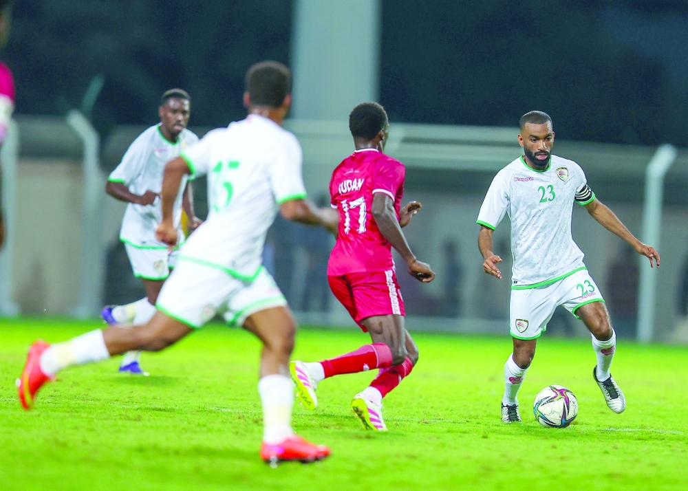 Oman player controls the ball. 