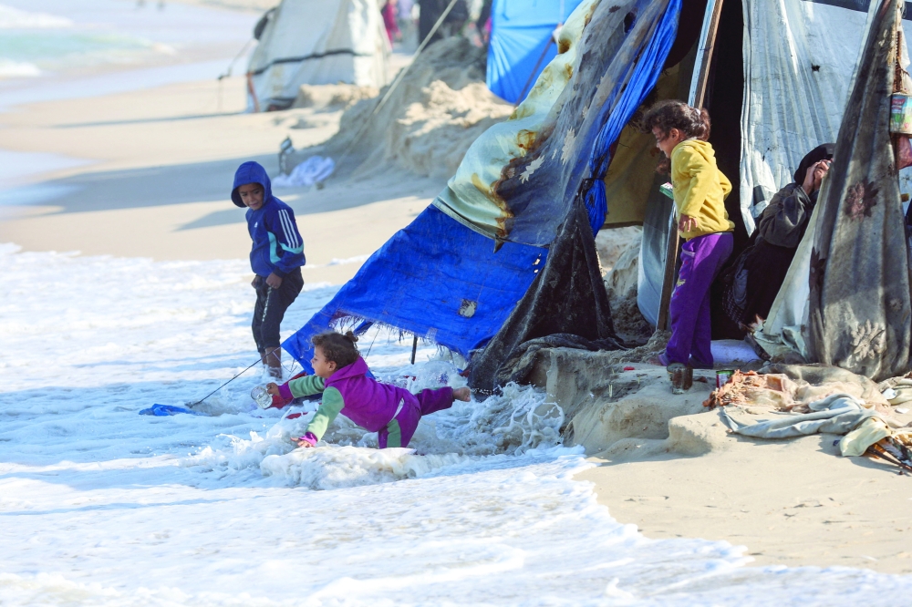 Palestinian kids take shelter in their tents, in Khan Yunis, southern Gaza Strip. — Reuters