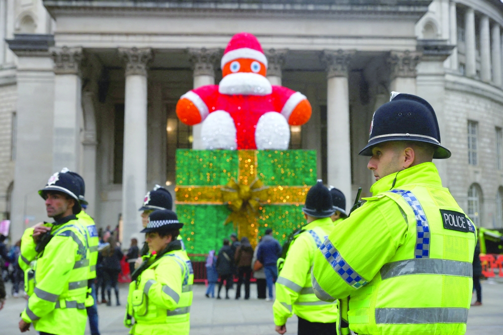 Police officers gather near Christmas decorations as climate-justice activists take part in a nationwide protest calling for stronger global climate actions, during the ongoing UN Climate Change Conference (COP30), on Saturday. - Reuters