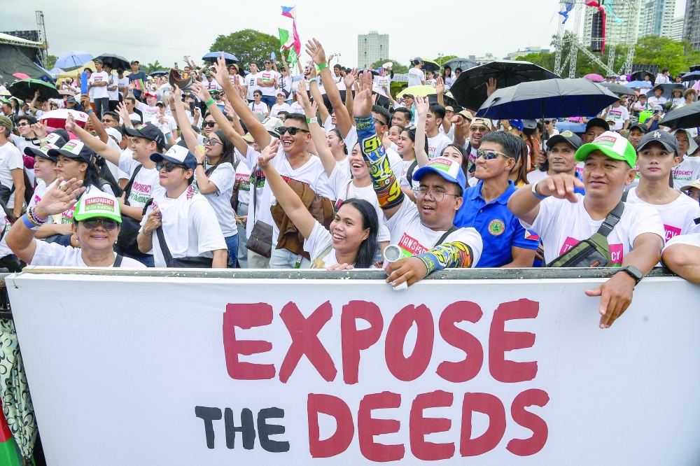 Members of religious group Iglesia ni Cristo attend an anti-corruption protest at a park in Manila on November 16, 2025. (Photo by Ted ALJIBE / AFP)