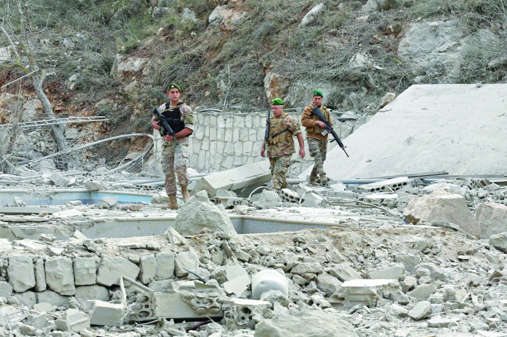 Lebanese soldiers inspect the site of an Israeli air strike in the village of Tair Felsay near Litani river. — AFP