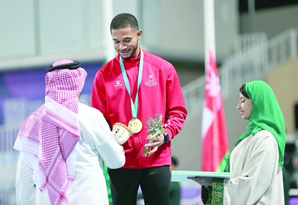 Oman's Ali bin Anwar al Balushi with his gold medal on the podium in Riyadh.