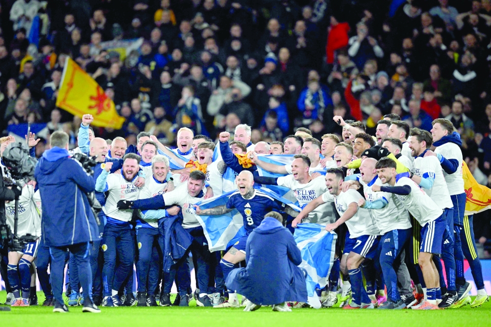 Scotland players celebrate on the pitch after the FIFA World Cup 2026 European qualification football match between Scotland and Denmark at Hampden Park. — AFP