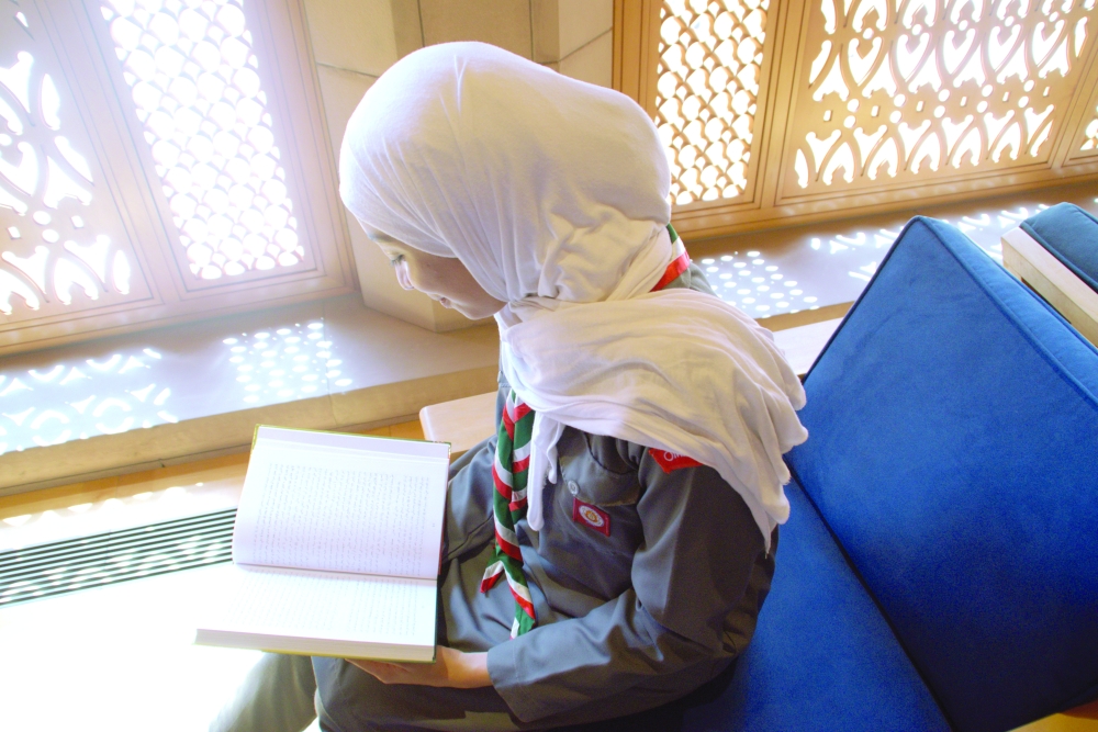 
Illuminating minds focus study in the geometric patterns of natural light, symbolizing the bright future of Omani women’s development 