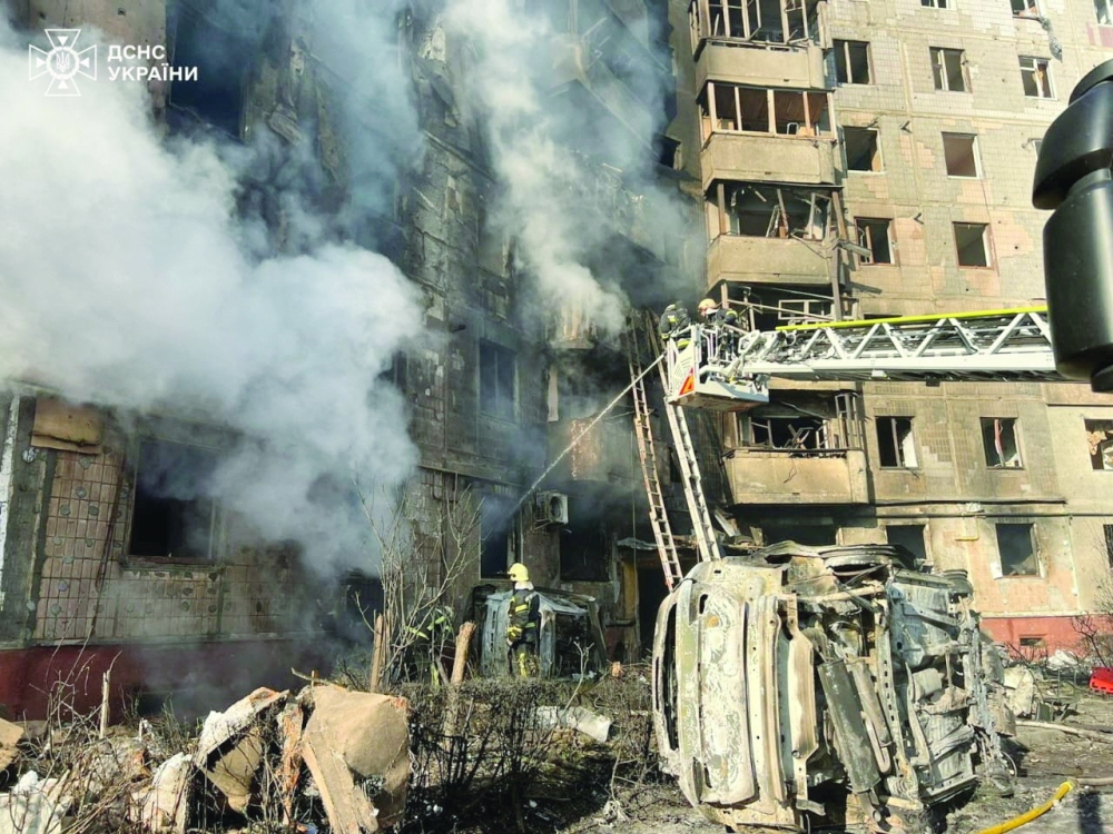 Rescuers work at the site of the apartment building hit by a Russian missile strike, in Ternopi. — Reuters