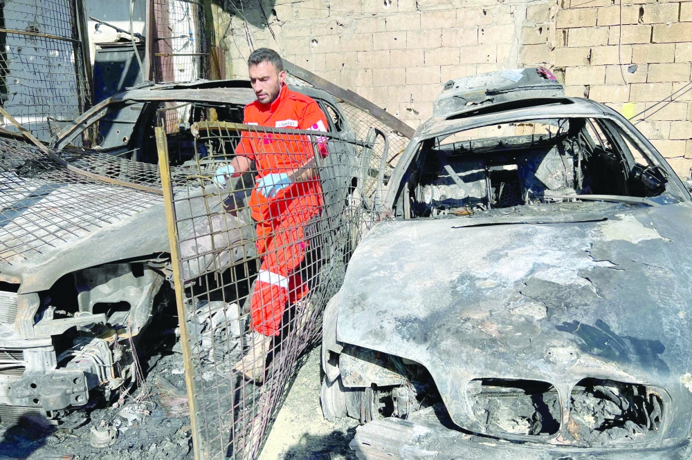 A first aid responder searches for human remains in the aftermath of an Israeli strike on the Ain al-Hilweh camp, in southern Lebanon. — AFP