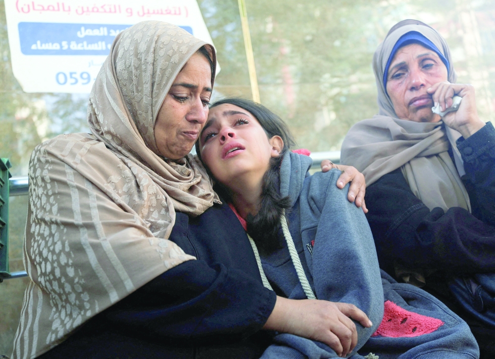 Mourners react as they attend the funeral of Palestinians, at Al-Shifa Hospital in Gaza City. — Reuters