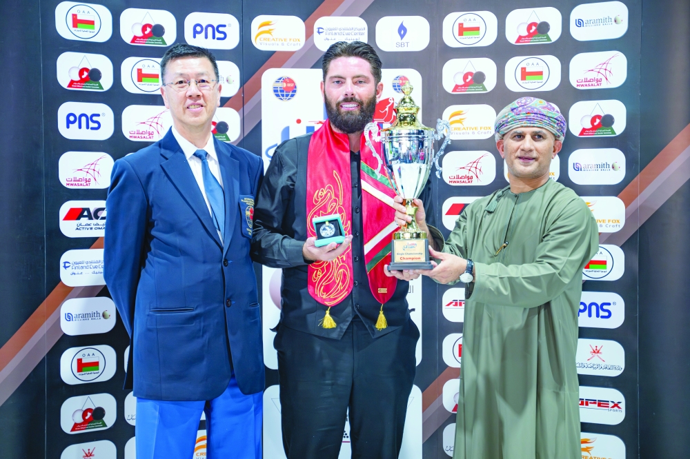 Snooker World Cup singles champion England’s Harvey Chandler receives the trophy.