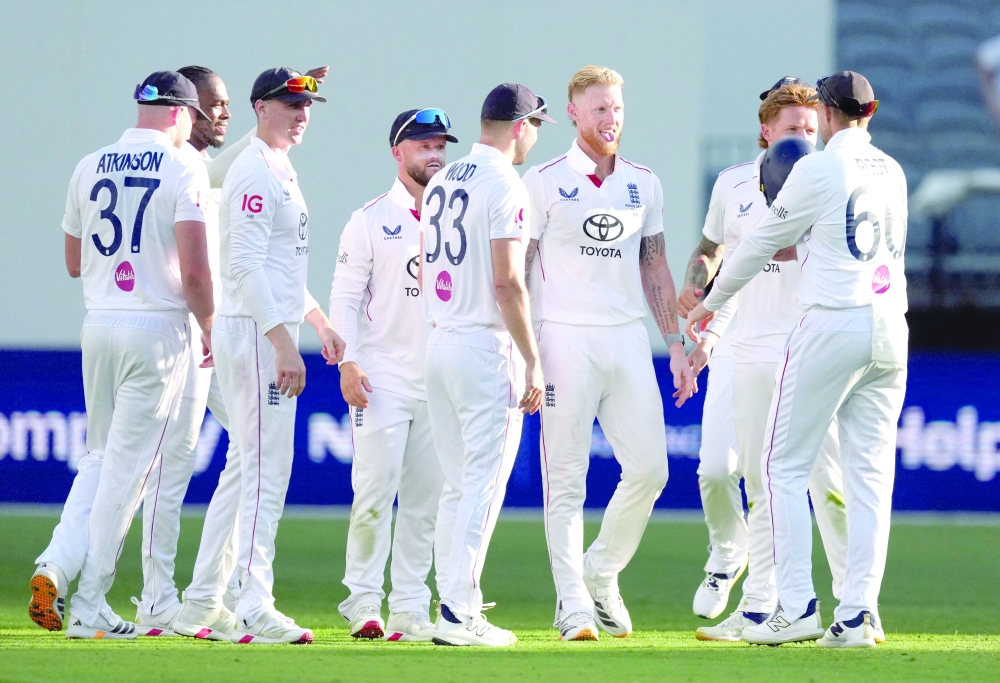 England's Ben Stokes celebrates with teammates after taking his fifth wicket, the wicket of Australia's Scott Boland caught out by Harry Brook. — Reuters