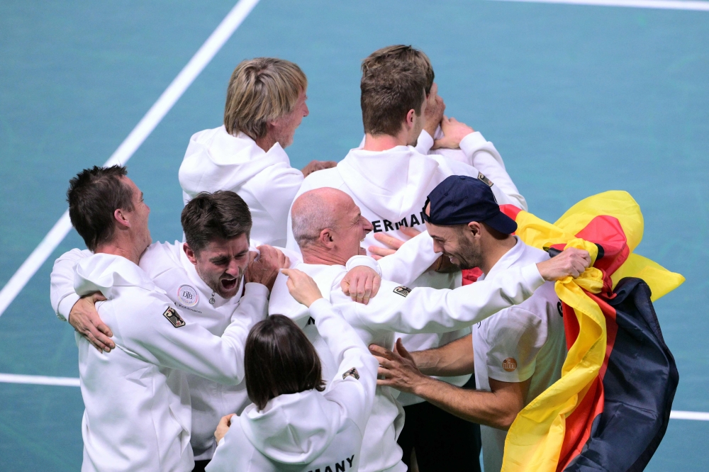 Germany's team celebrates after their victory 2-1 over Argentina in the men's Davis Cup quarter finals at the Super Tennis Arena, in Bologna, northen Italy, on November 20, 2025.  (Photo by Tiziana FABI / AFP)
