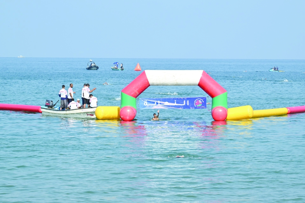 One of the swimmers celebrates after crossing the finish line. 