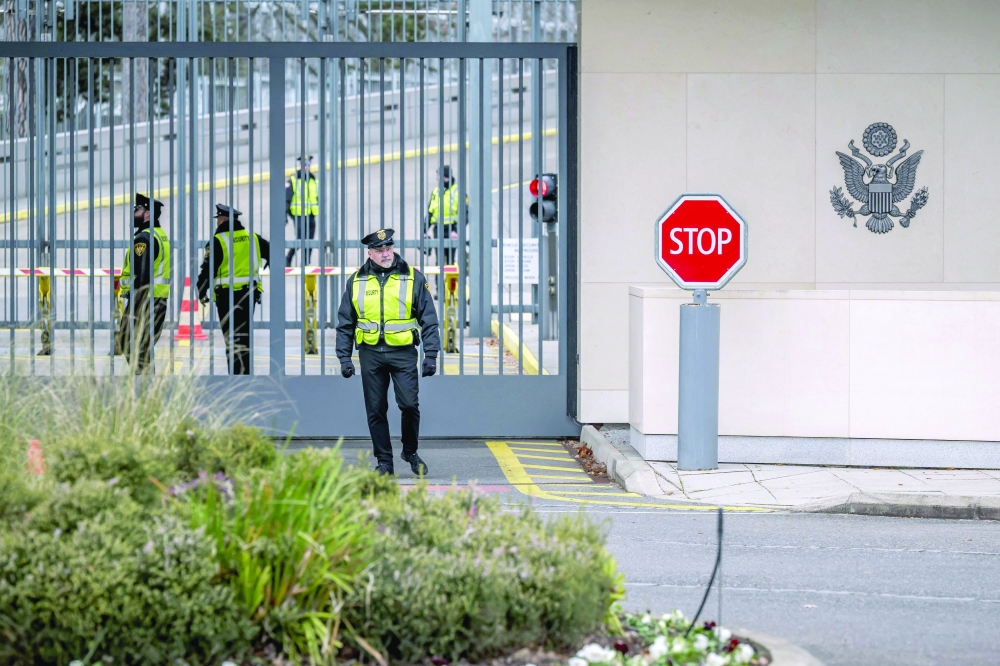 Officers of the US security stand guard at the Missions of USA in Geneva. — AFP