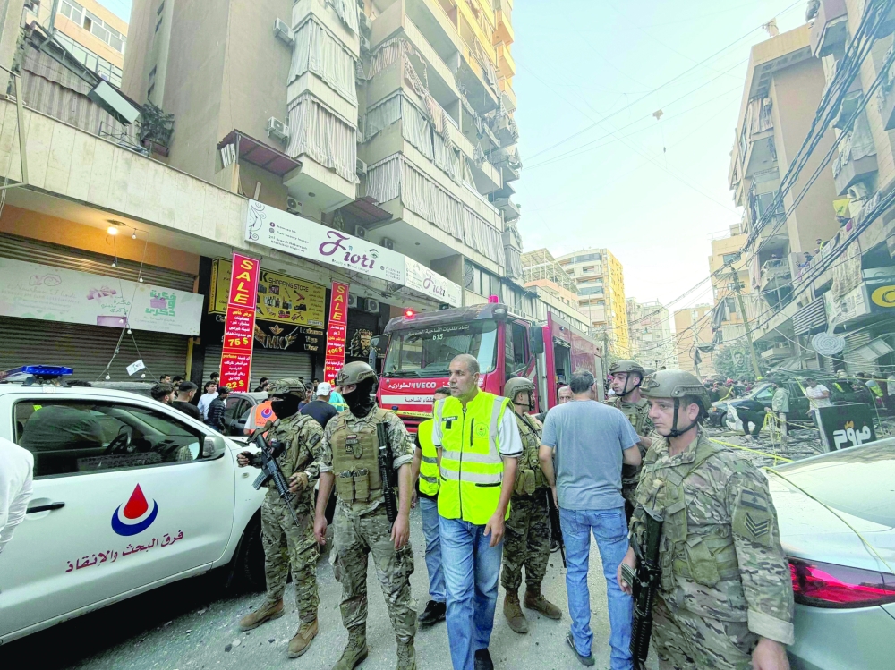 Lebanese army soldiers secure the site of an Israeli air strike that targeted a residential building in Beirut southern Haret Hreik neighborhood on November 23, 2025. Israel's military said on November 23, 2025, that it had carried out a strike on a senior member of the Iran-backed Hezbollah militant group in Lebanon's capital. 