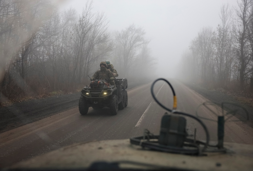Ukrainian servicemen ride a military buggy along a road near a front line, amid Russia's attack on Ukraine, near the frontline town of Pokrovsk in Donetsk region