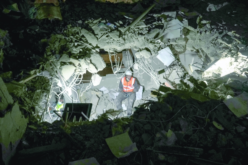 Rescuers search for survivors at the site of an Israeli air attack, in Beirut. — AFP