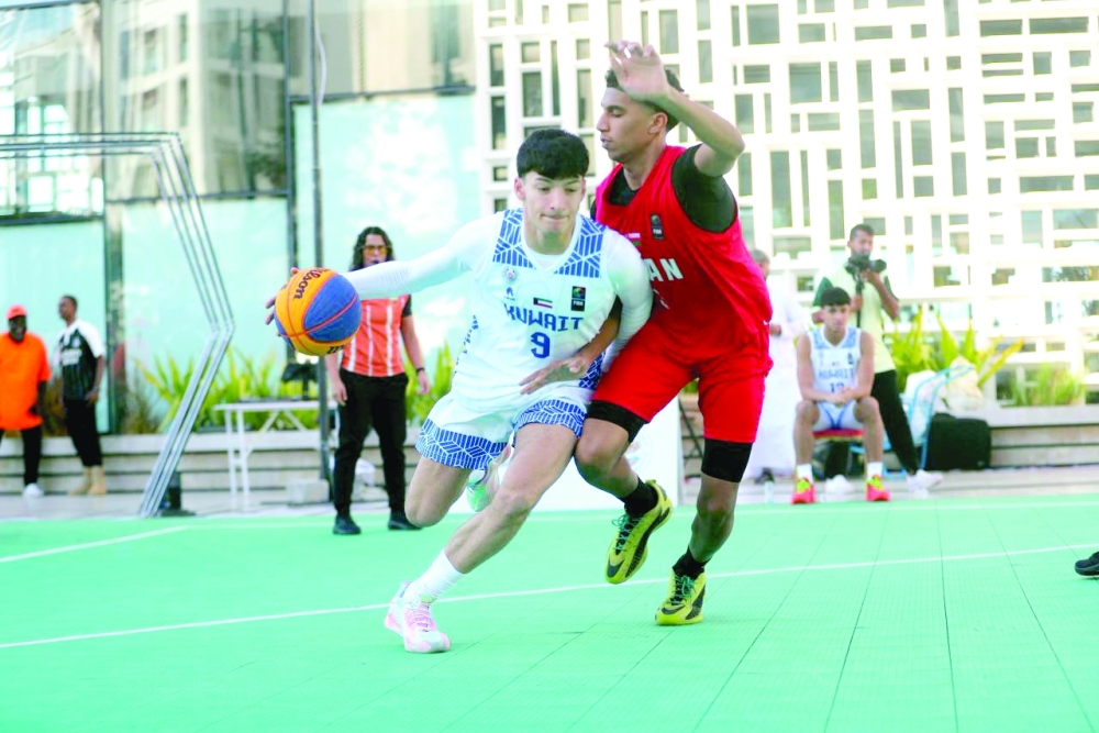 Oman and Kuwait players fight for the ball. — Ammar al Musafir