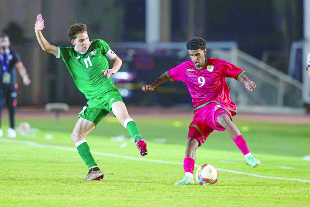 Oman and Syria players fight for the ball.