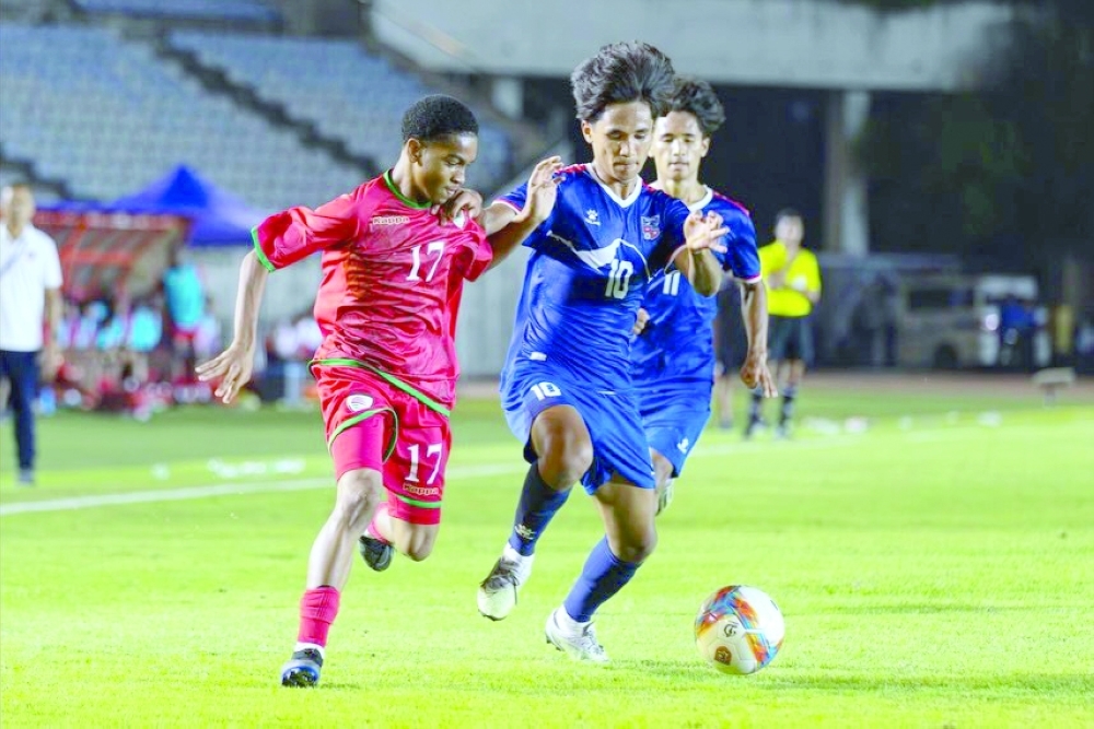Oman and Nepal players fight for the ball.