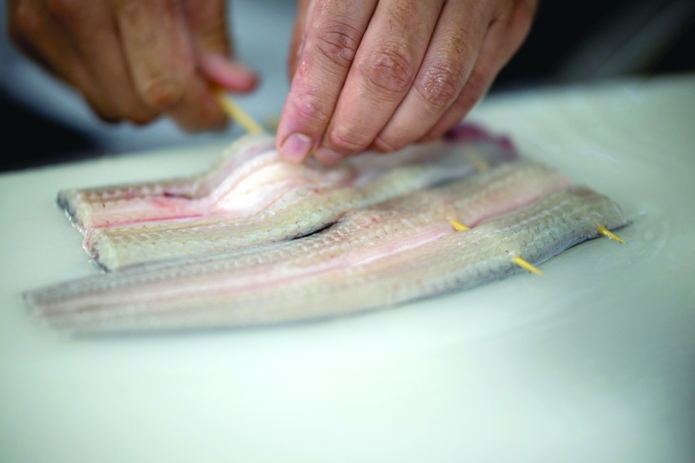 A chef cooks eels in a restaurant of Hiranuma eel farm in Kamisato of Saitama Prefecture. — AFP
