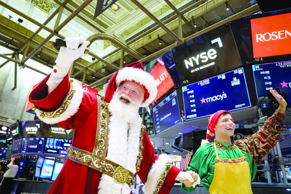 Macy's Santa Claus is greeted by traders on the floor at the New York Stock Exchange (NYSE) in New York City. - Reuters