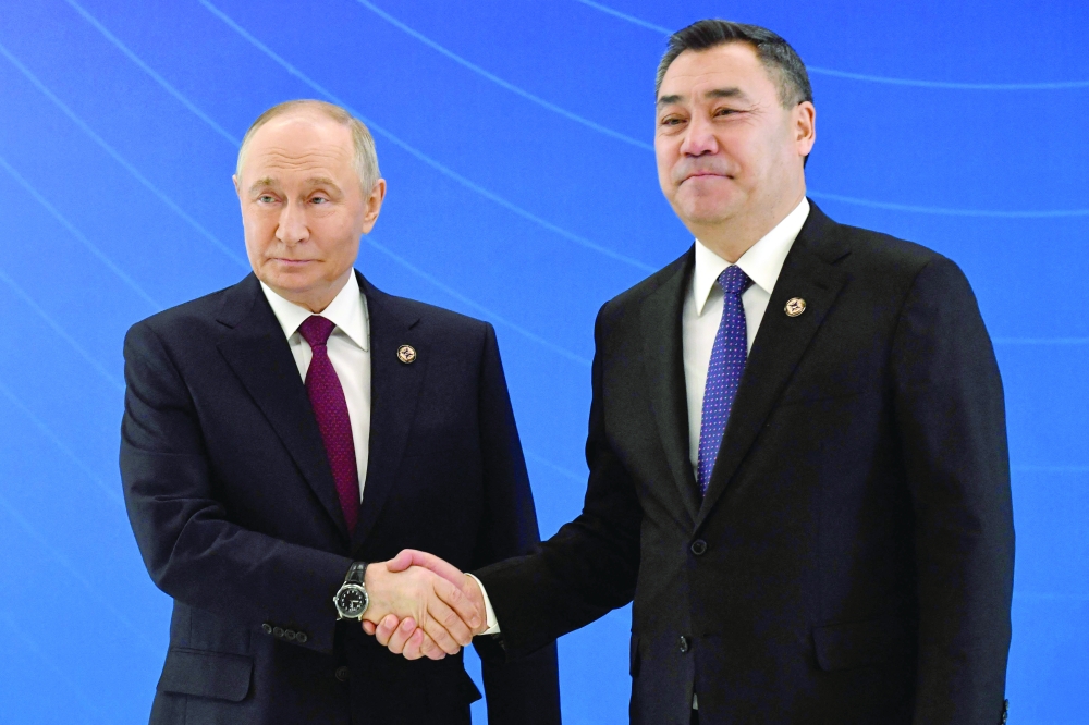 Kyrgyz President Sadyr Japarov greets Russian President Vladimir Putin at the Palace of Unity presidential residence in Bishkek - AFP
