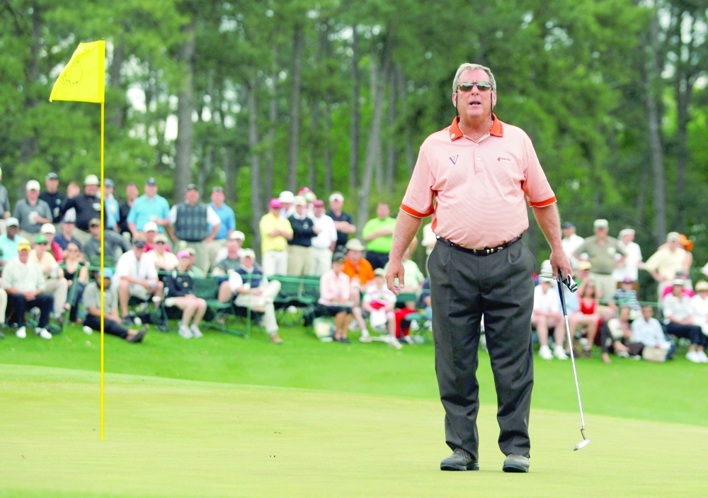 Former champion Fuzzy Zoeller shouts to the gallery on the 18th green before stroking his final putt in his final competitive round during second round play at the 2009 Masters golf tournament at the Augusta National Golf Club in Georgia on April 10, 2009. — Reuters