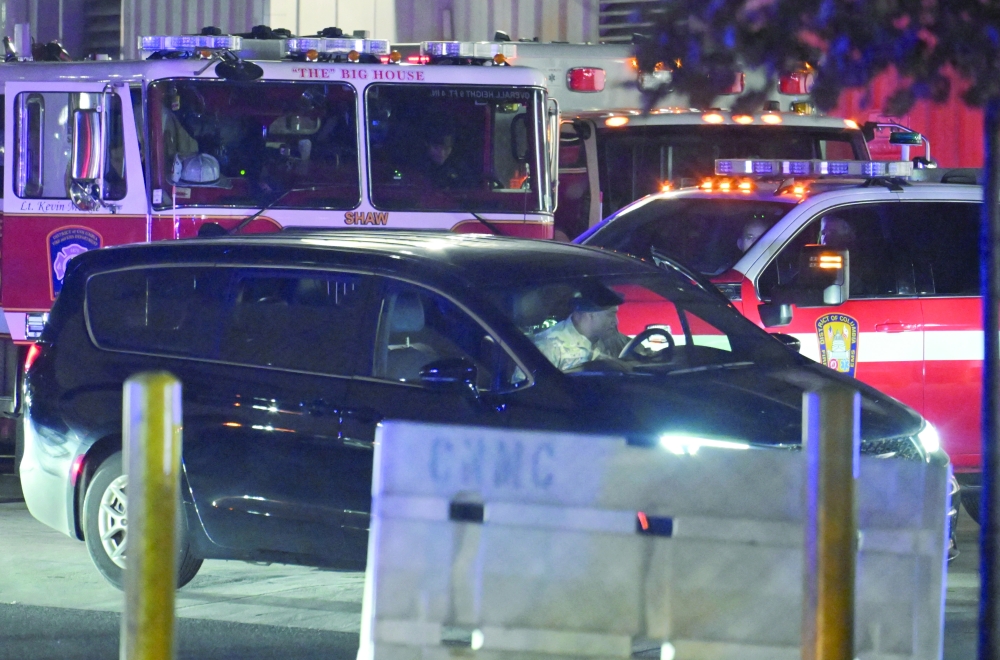 A member of the National Guard sits inside a car on the day the body of slain West Virginia National Guard member Sarah Beckstrom is transferred from Medstar Washington Hospital Centre, a day after she was shot in Washington, DC. — Reuters