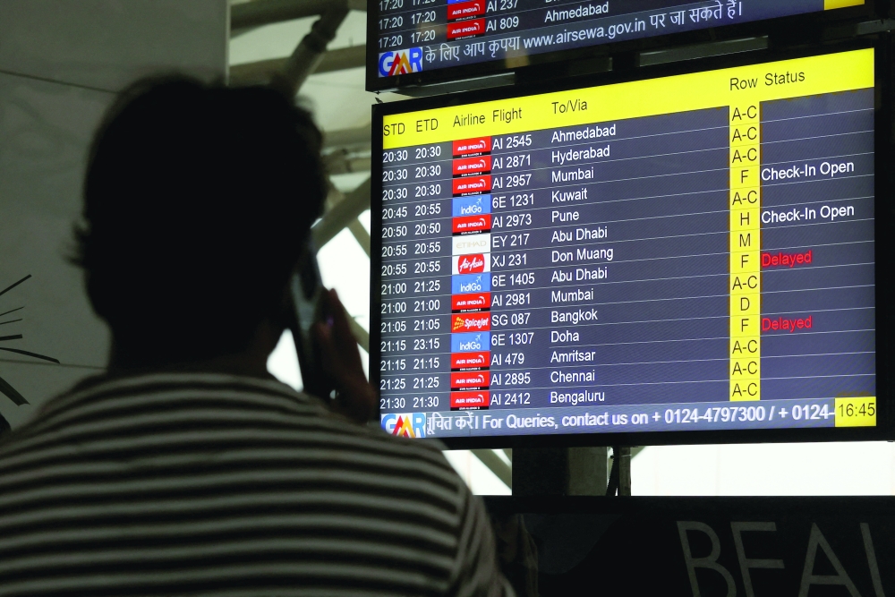 A screen displays delays in IndiGo flights at the Indira Gandhi International Airport in Delhi, India, on Saturday. — Reuters