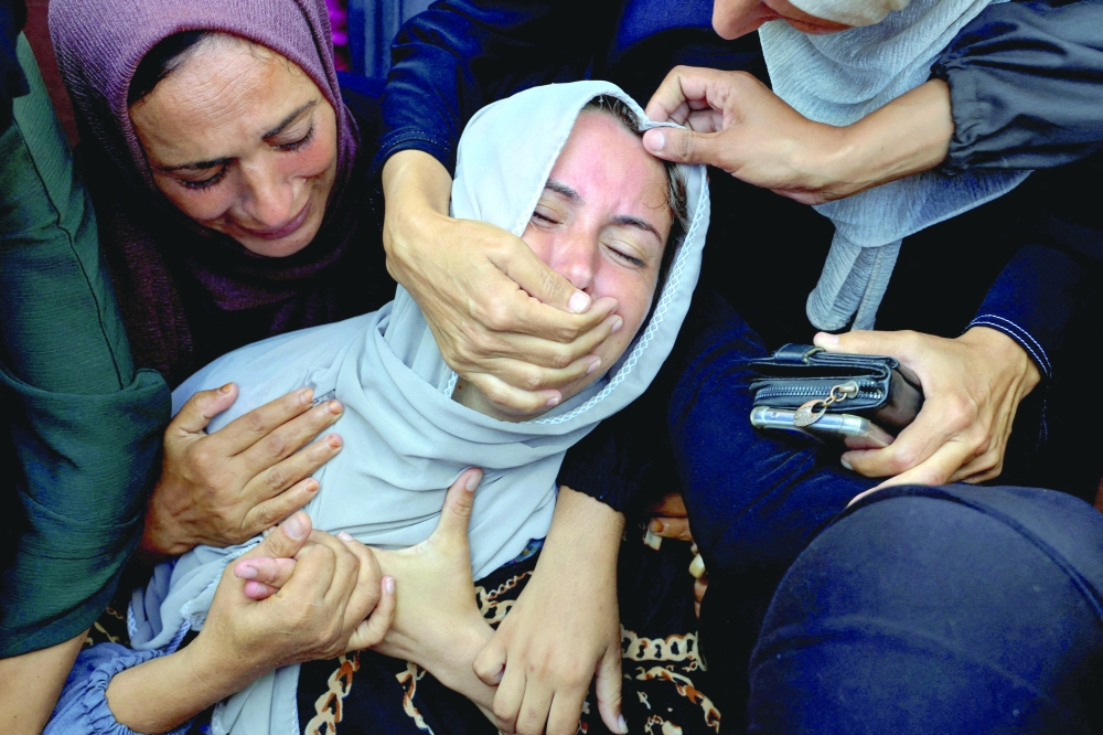 Mourners react during the funeral of 12-year-old Wasem Abu Daqa, who was killed overnight by Israeli fire, according to medics, at Nasser Hospital in Khan Yunis, southern Gaza Strip, July 20, 2025. REUTERS