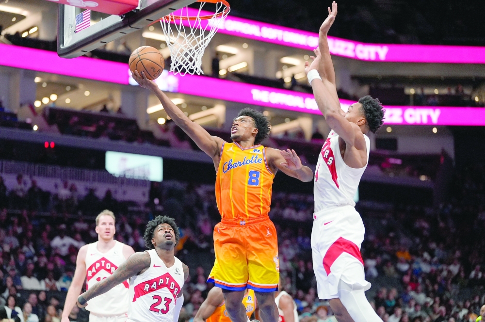 Charlotte Hornets guard Collin Sexton (8) goes to the basket defended by Toronto Raptors forward Scottie Barnes (4). — Reuters 